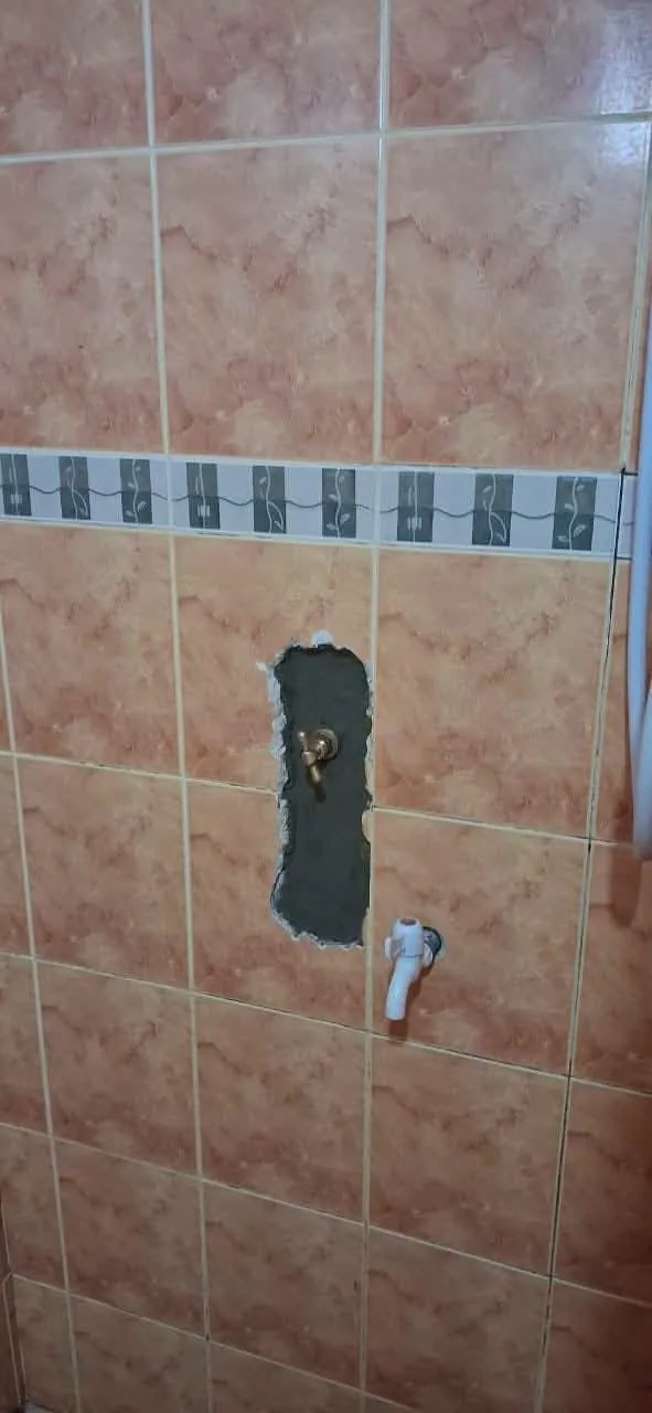 Wall opened neatly around a concealed pipe valve