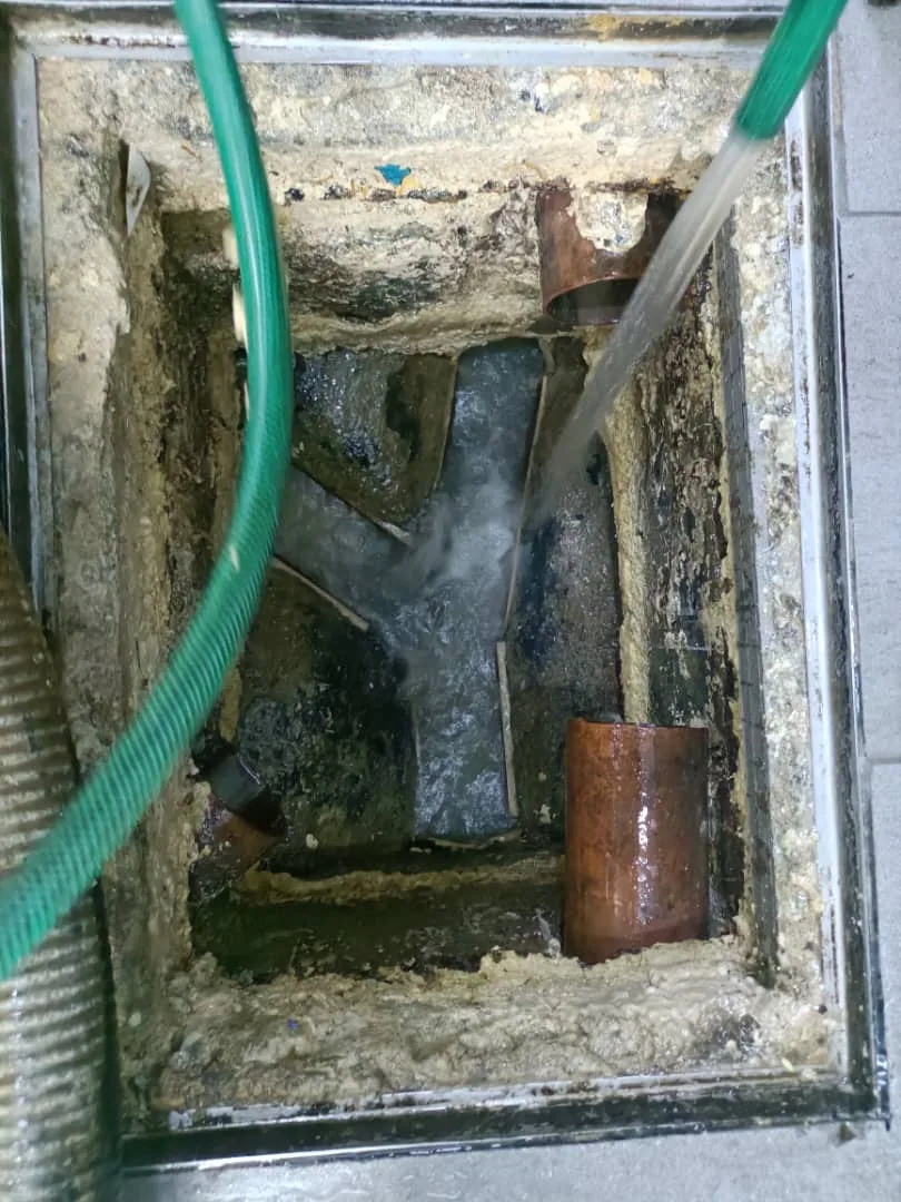 Drain chamber being flushed and cleaned
