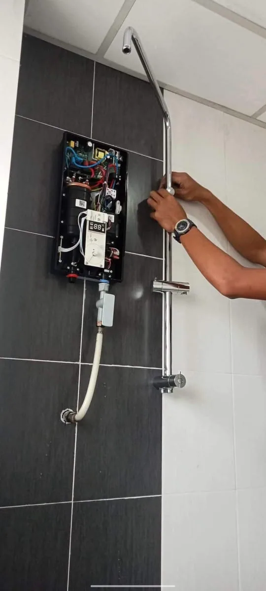 Technician servicing an open instant water heater