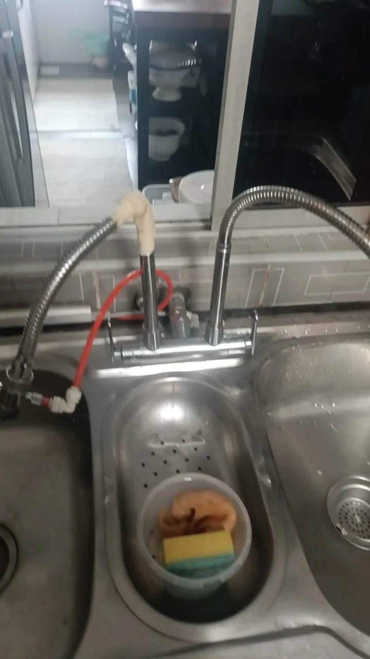 Kitchen sink faucet and supply hoses during repair