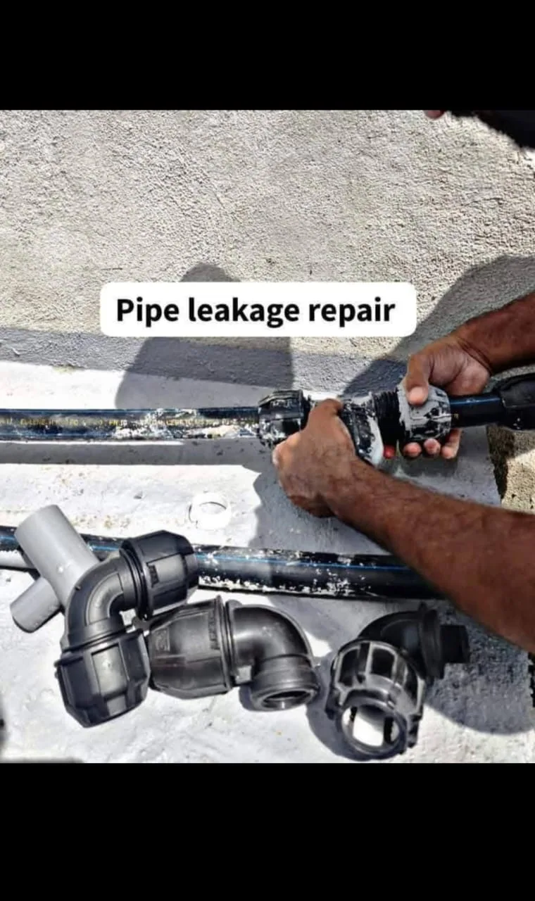 Technician reconnecting fittings during a pipe leak repair