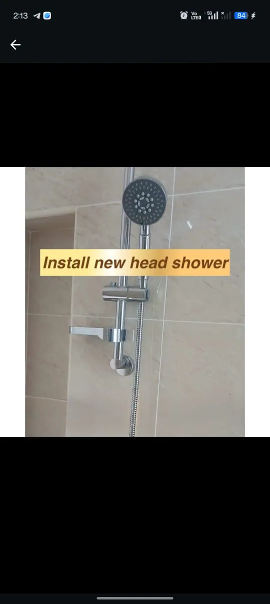 New rainfall shower head installed on a tiled wall