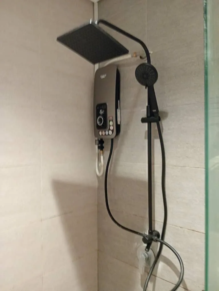Rainfall shower system installed beside a water heater
