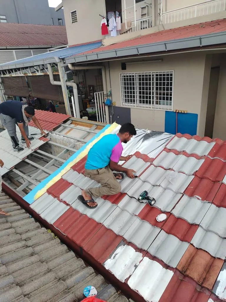 Plumbing team repairing a tiled roof during leak-prevention work